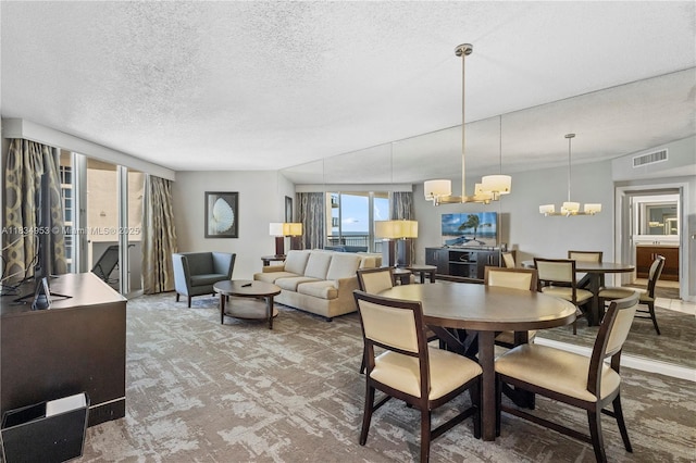 17375 Collins Ave Unit 1004, Sunny Isles Beach, FL 33160 - dining room with a chandelier, a textured ceiling, and carpet flooring