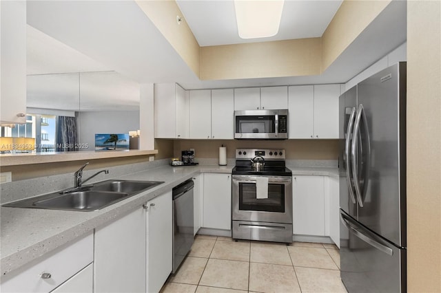 17375 Collins Ave Unit 1004, Sunny Isles Beach, FL 33160 - kitchen featuring stainless steel appliances, white cabinetry, light countertops, and light tile patterned floors