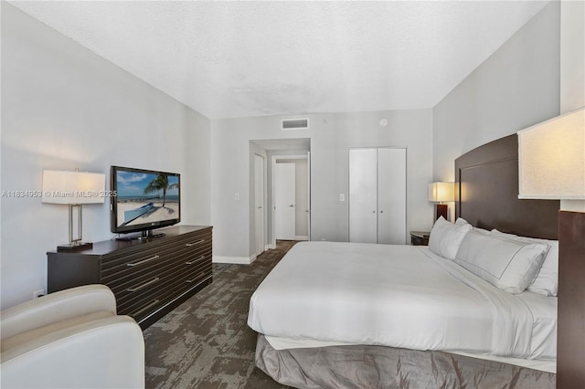 17375 Collins Ave Unit 1004, Sunny Isles Beach, FL 33160 - bedroom featuring dark colored carpet, a closet, and a textured ceiling