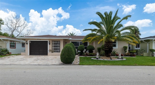 4811 NW 58th St, Tamarac, FL 33319 - ranch-style house featuring driveway, stucco siding, an attached garage, and a front yard