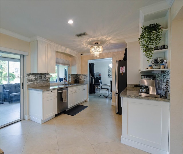 4811 NW 58th St, Tamarac, FL 33319 - kitchen featuring appliances with stainless steel finishes, open shelves, tasteful backsplash, white cabinets, and plenty of natural light