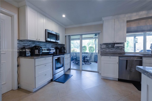 4811 NW 58th St, Tamarac, FL 33319 - kitchen featuring appliances with stainless steel finishes, tasteful backsplash, crown molding, white cabinets, and recessed lighting