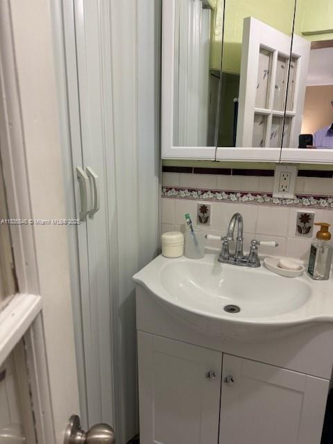 6424 SW 20th St, Miramar, FL 33023 - bathroom featuring vanity and tasteful backsplash