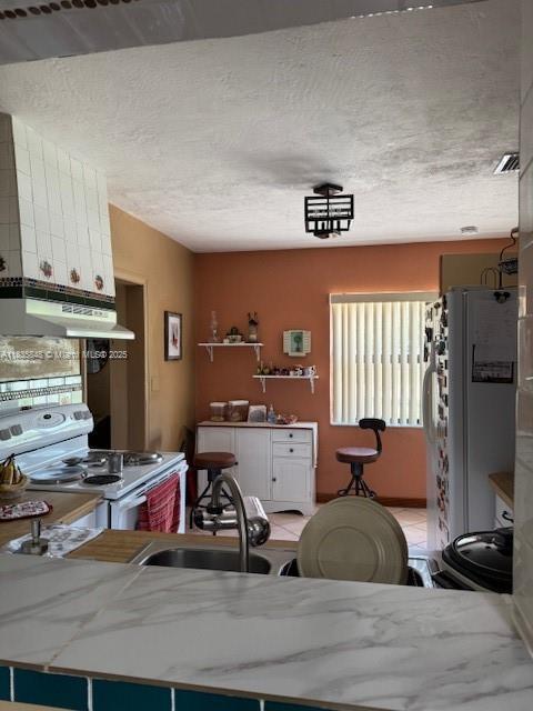 6424 SW 20th St, Miramar, FL 33023 - kitchen featuring under cabinet range hood and white appliances