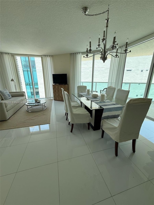 150 Sunny Isles Blvd Unit 1-1401, Sunny Isles Beach, FL 33160 - tiled dining room with a chandelier, plenty of natural light, and a textured ceiling