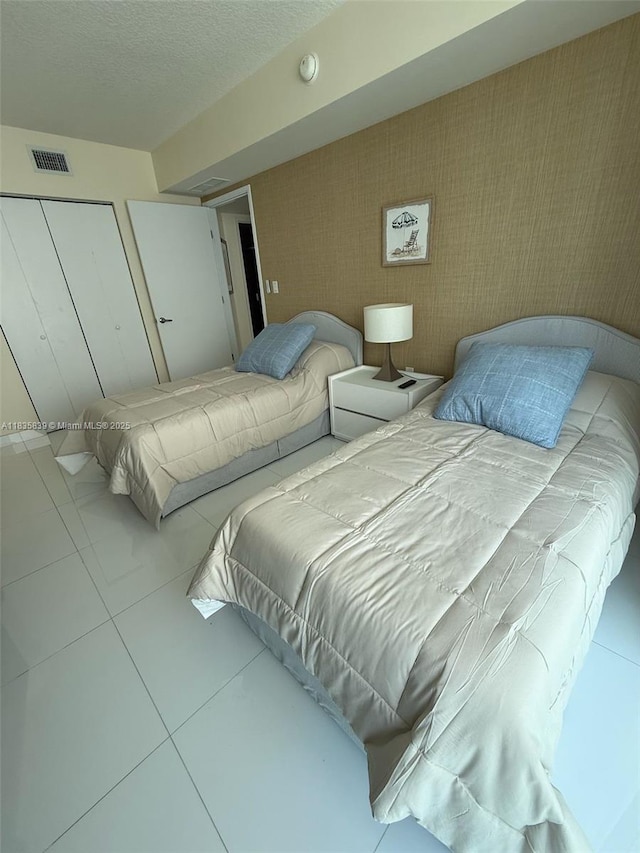 150 Sunny Isles Blvd Unit 1-1401, Sunny Isles Beach, FL 33160 - bedroom featuring tile patterned flooring and a closet
