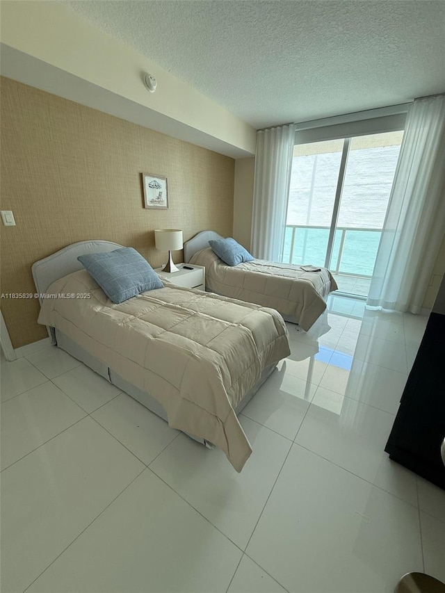 150 Sunny Isles Blvd Unit 1-1401, Sunny Isles Beach, FL 33160 - tiled bedroom with access to outside, a textured ceiling, and wallpapered walls
