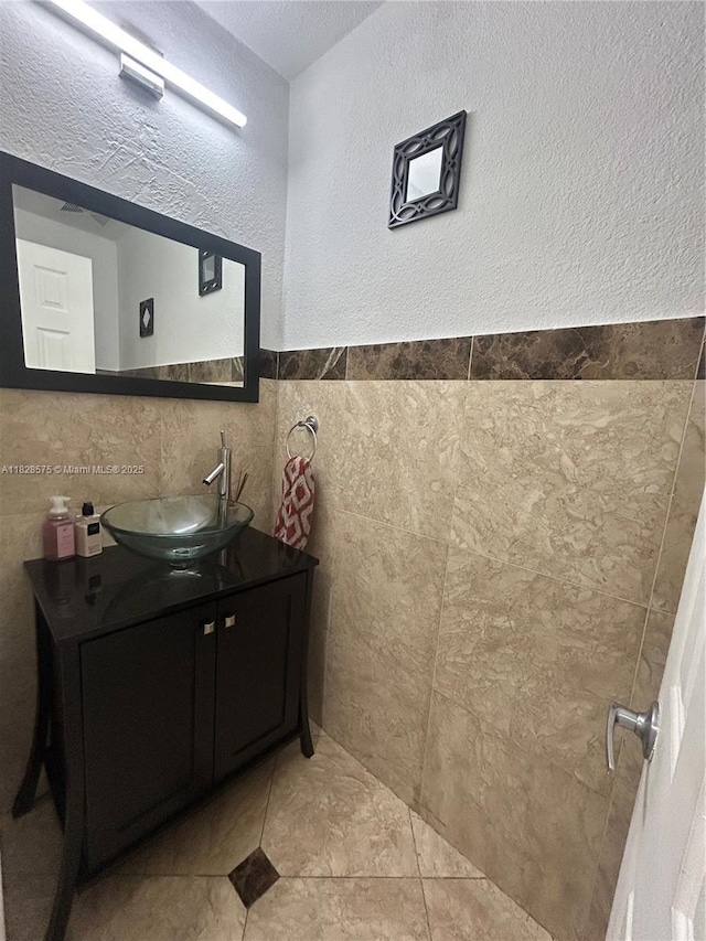7060 W 2nd Way Unit 7060, Hialeah, FL 33014 - bathroom featuring vanity, tile walls, and a textured wall