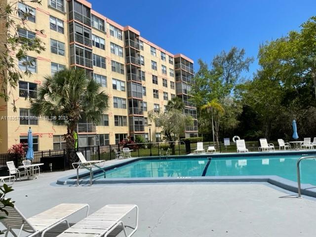 17890 W Dixie Hwy Unit 219, Miami, FL 33160 - community pool featuring a patio area