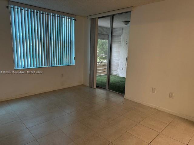 17890 W Dixie Hwy Unit 219, Miami, FL 33160 - spare room featuring light tile patterned floors