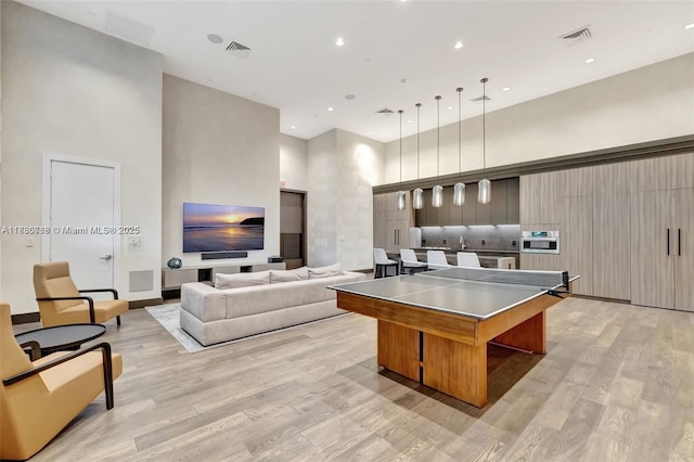 4100 Island Blvd Unit 701, Aventura, FL 33160 - kitchen with a high ceiling, light wood-type flooring, a spacious island, modern cabinets, and decorative light fixtures