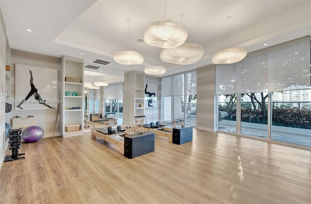 4100 Island Blvd Unit 701, Aventura, FL 33160 - exercise room with wood finished floors, a raised ceiling, and healthy amount of natural light