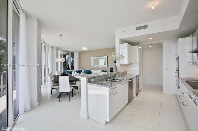 4100 Island Blvd Unit 701, Aventura, FL 33160 - kitchen with white cabinets, light stone countertops, and light tile patterned floors