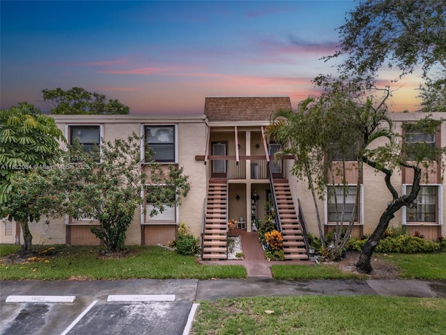 7331 NW 18th St Unit 205, Margate, FL 33063 - property at dusk with stairway and uncovered parking