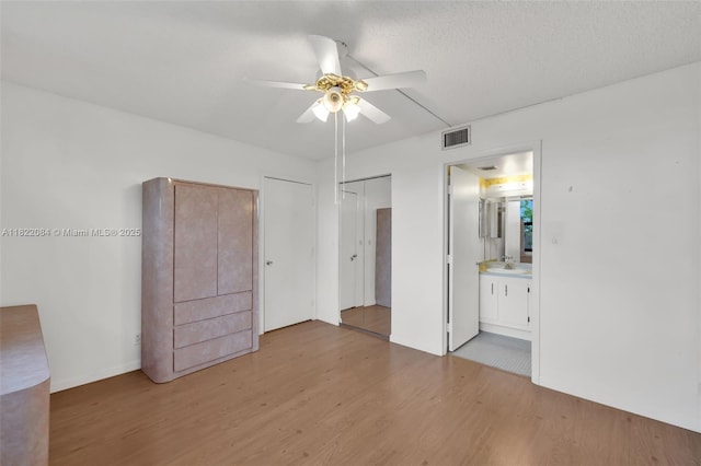 7331 NW 18th St Unit 205, Margate, FL 33063 - unfurnished bedroom featuring light wood-type flooring, ceiling fan, and connected bathroom