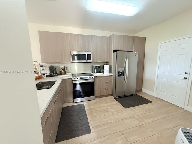 15260 SW 91st Ln, Miami, FL 33196 - kitchen with appliances with stainless steel finishes, light countertops, modern cabinets, and wood tiled floors