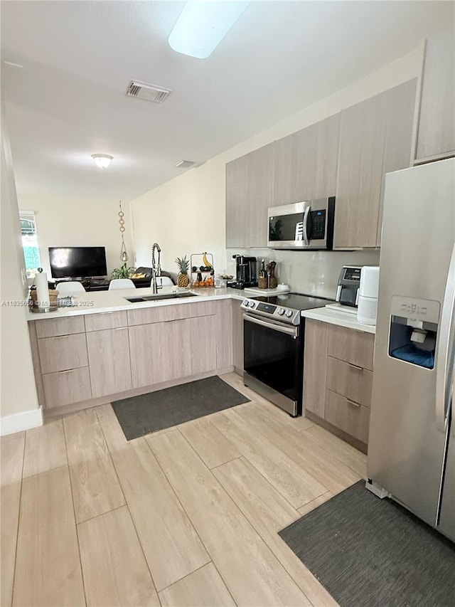 15260 SW 91st Ln, Miami, FL 33196 - kitchen featuring appliances with stainless steel finishes, light brown cabinets, modern cabinets, and light countertops
