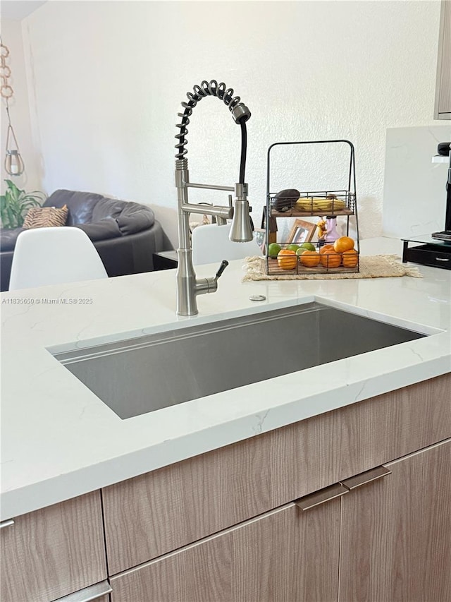 15260 SW 91st Ln, Miami, FL 33196 - kitchen view of light stone counters and a textured wall