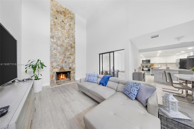 6637 NW 181st Ln, Hialeah, FL 33015 - living area with light wood-style floors, high vaulted ceiling, and a stone fireplace