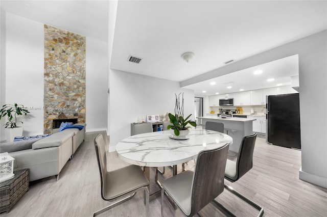 6637 NW 181st Ln, Hialeah, FL 33015 - dining space with light wood-style floors, a stone fireplace, and recessed lighting