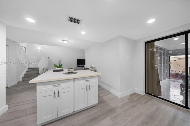 6637 NW 181st Ln, Hialeah, FL 33015 - kitchen featuring light wood-style floors, white cabinets, light countertops, recessed lighting, and a center island