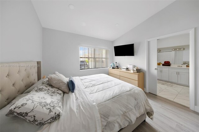 6637 NW 181st Ln, Hialeah, FL 33015 - bedroom with lofted ceiling, ensuite bath, and light wood-style flooring