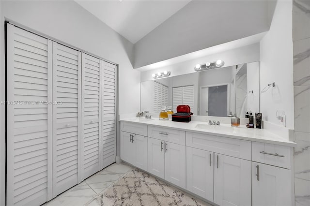 6637 NW 181st Ln, Hialeah, FL 33015 - bathroom featuring a closet, marble look tile flooring, double vanity, and vaulted ceiling