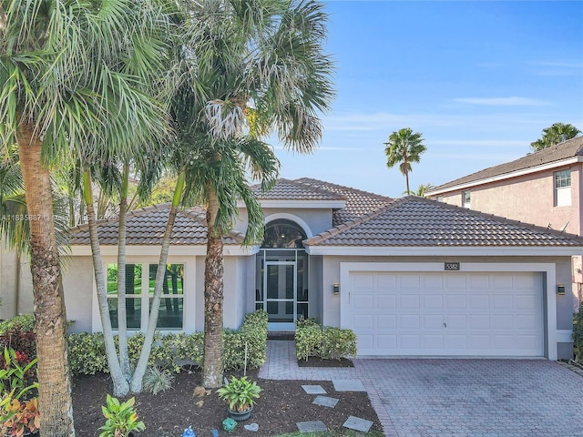 5382 NW 120th Ave, Coral Springs, FL 33076 - view of front of property with stucco siding, a garage, decorative driveway, and a tiled roof