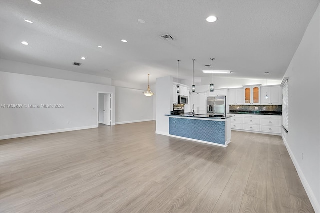 5382 NW 120th Ave, Coral Springs, FL 33076 - unfurnished living room with recessed lighting, light wood finished floors, vaulted ceiling, and a textured ceiling