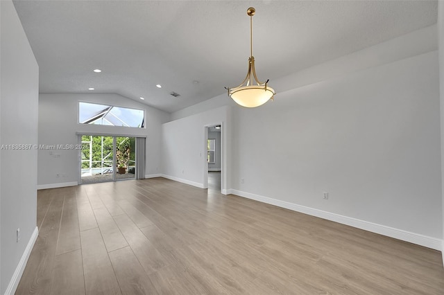 5382 NW 120th Ave, Coral Springs, FL 33076 - unfurnished living room with wood finished floors, vaulted ceiling, and recessed lighting