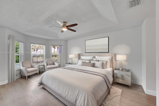 5382 NW 120th Ave, Coral Springs, FL 33076 - bedroom featuring a tray ceiling, a ceiling fan, and light wood finished floors