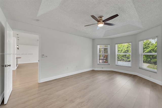 5382 NW 120th Ave, Coral Springs, FL 33076 - unfurnished room featuring a textured ceiling, ceiling fan, healthy amount of natural light, light wood-type flooring, and a smoke detector