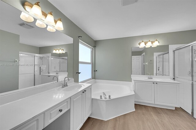 5382 NW 120th Ave, Coral Springs, FL 33076 - bathroom with wood finished floors, two vanities, a bath, and a stall shower