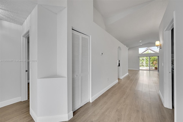 5382 NW 120th Ave, Coral Springs, FL 33076 - hallway featuring lofted ceiling, wood finished floors, and arched walkways