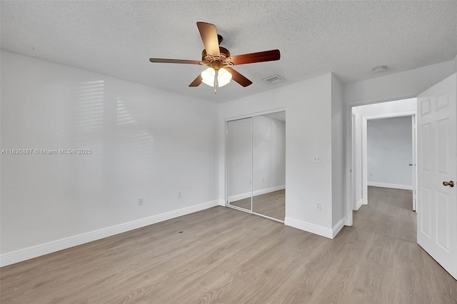 5382 NW 120th Ave, Coral Springs, FL 33076 - unfurnished bedroom featuring light wood-type flooring, a textured ceiling, a closet, and ceiling fan