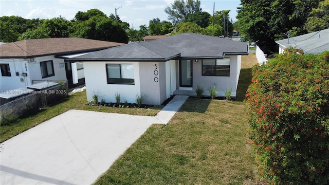 500 NW 7th Ct, Hallandale Beach, FL 33009 - view of front of property featuring a front yard, a patio, and roof with shingles
