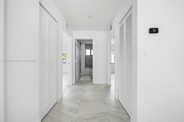 500 NW 7th Ct, Hallandale Beach, FL 33009 - corridor featuring light marble finish floors