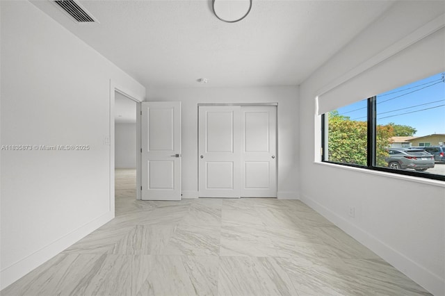 500 NW 7th Ct, Hallandale Beach, FL 33009 - unfurnished bedroom featuring baseboards and a closet