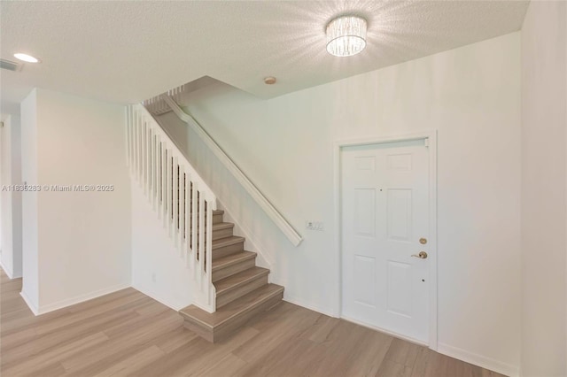 1326 Majesty Ter, Weston, FL 33327 - entryway featuring a textured ceiling, light wood-style flooring, stairs, and recessed lighting