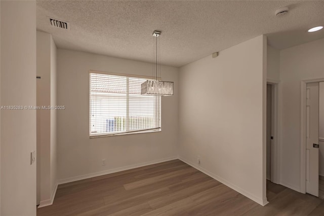 1326 Majesty Ter, Weston, FL 33327 - unfurnished room with wood finished floors, a textured ceiling, a chandelier, and a smoke detector