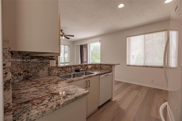 1326 Majesty Ter, Weston, FL 33327 - kitchen featuring white dishwasher, refrigerator, a textured ceiling, a ceiling fan, and a peninsula