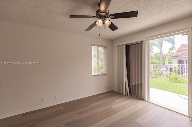 1326 Majesty Ter, Weston, FL 33327 - spare room featuring healthy amount of natural light, wood finished floors, a ceiling fan, and a textured ceiling