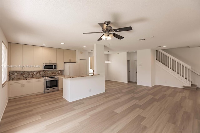 1326 Majesty Ter, Weston, FL 33327 - kitchen featuring stainless steel appliances, open floor plan, ceiling fan, light wood finished floors, and recessed lighting