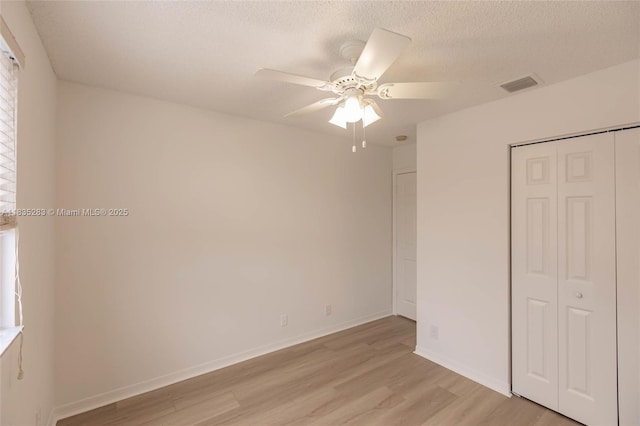1326 Majesty Ter, Weston, FL 33327 - unfurnished bedroom featuring light wood-style floors, a closet, a textured ceiling, and ceiling fan
