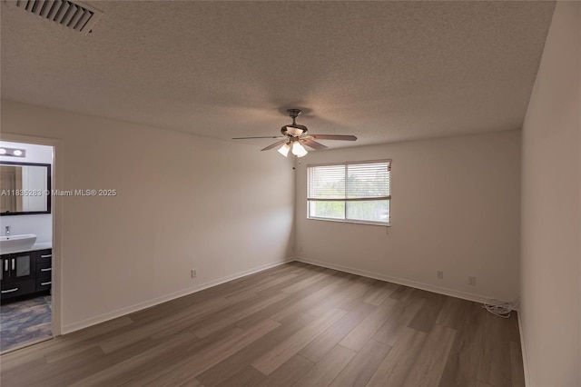 1326 Majesty Ter, Weston, FL 33327 - unfurnished room featuring wood finished floors, ceiling fan, and a textured ceiling