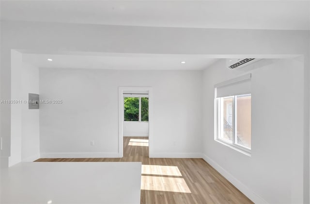 1260 SW 4th St, Miami, FL 33135 - spare room featuring a wall mounted AC, light wood-type flooring, and recessed lighting