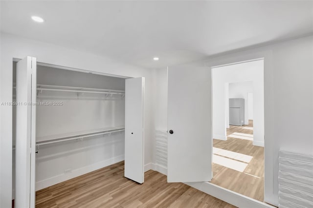 1260 SW 4th St, Miami, FL 33135 - unfurnished bedroom with wood finished floors, recessed lighting, fridge, and a closet