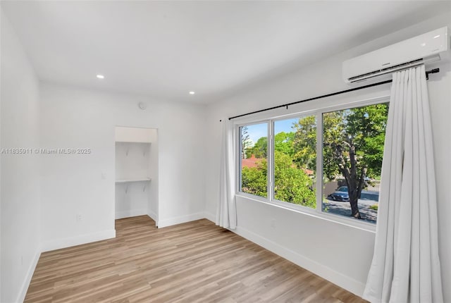 1260 SW 4th St, Miami, FL 33135 - unfurnished room with a wall unit AC, light wood-style floors, and recessed lighting