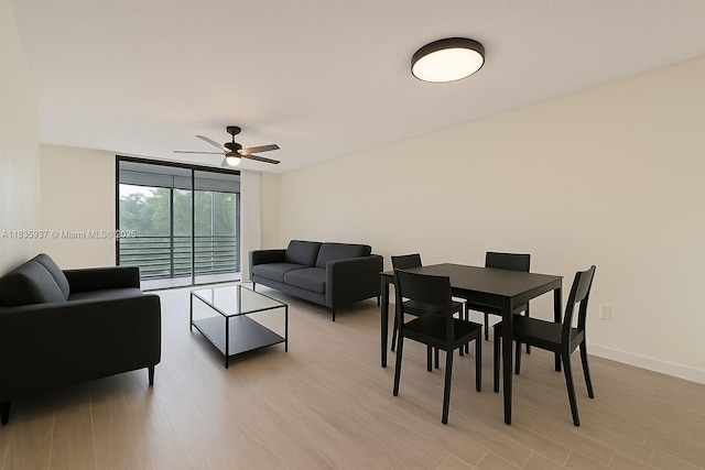 1001 Colony Point Cir Unit 419, Pembroke Pines, FL 33026 - living room featuring a ceiling fan, expansive windows, and light wood finished floors