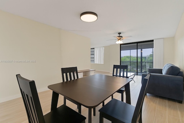 1001 Colony Point Cir Unit 419, Pembroke Pines, FL 33026 - dining space featuring a wall of windows, ceiling fan, and light wood-style flooring